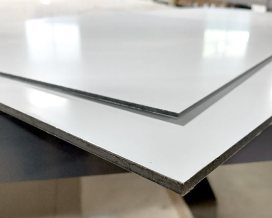 A close-up of a white metal aluminum composite sheet